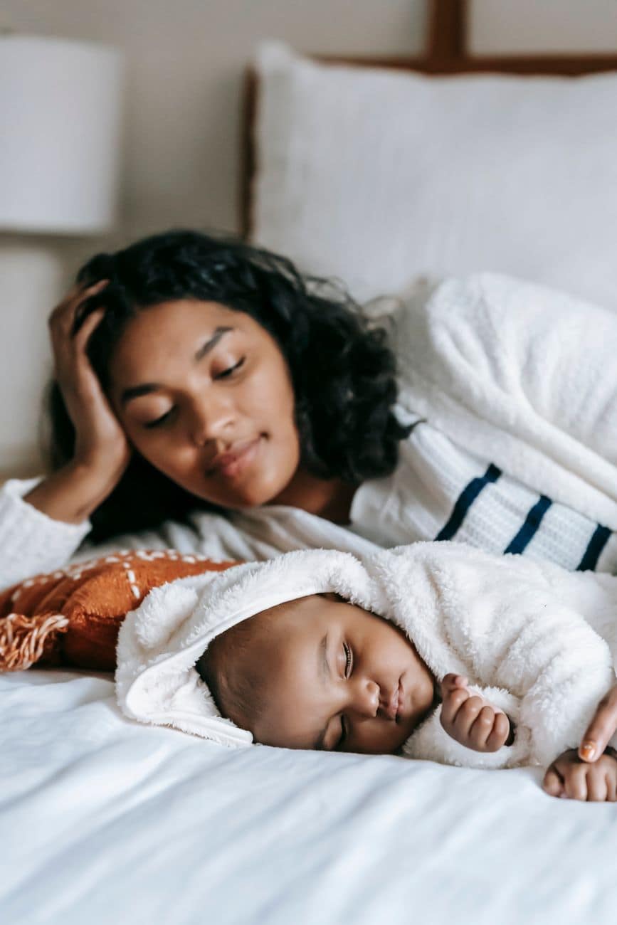 mother looking at her sleeping baby